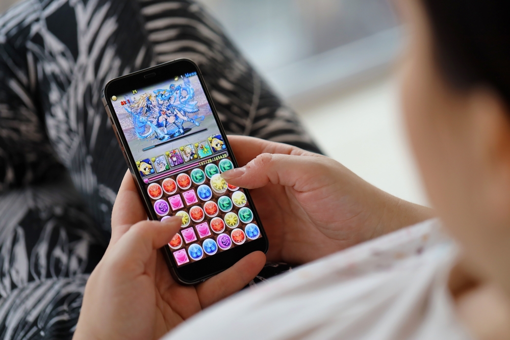 Overhead photo of a person playing a puzzle-type video game.